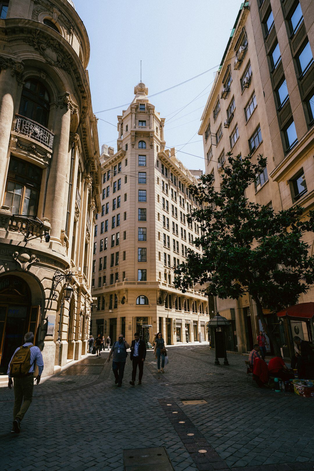 Narrow downtown Santiago street with pedestrians and old buildings